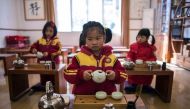 This picture taken on February 2, 2016 shows girls learning to perform a tea ceremony at a Confucius kindergarten in Wuhan. With central government backing, hundreds of private schools dedicated to Confucian teachings have sprung up across the country in 