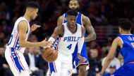 Philadelphia 76ers forward Nerlens Noel (4) dribbles past guard Timothe Luwawu-Cabarrot (20) and New York Knicks center Kyle O'Quinn (9) during the second half at Wells Fargo Center. Bill Streicher