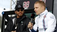 Mercedes F1 driver Lewis Hamilton (L) watches as Williams F1 driver Valtteri Bottas speaks to fans at the Australian Formula One Grand Prix in Melbourne. REUTERS/Brandon Malone/File Photo
