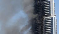 This file photo taken on January 01, 2016 shows smoke billowing from the Address Downtown Hotel in Dubai in the aftermath of a huge fire that engulfed several floors of the building. Dubai on January 22, 2017 announced tougher fire rules in a bid to minim