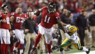 Julio Jones of the Atlanta Falcons runs after a catch for a 73 yard touchdown against Damarious Randall of the Green Bay Packers in the third quarter in the NFC Championship Game at the Georgia Dome on January 22, 2017 (AFP Photo/Rob Carr)