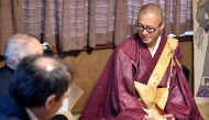 This picture taken on November 10, 2016 shows Buddhist monk Kaichi Watanabe (R) speaking to relatives during the one-year anniversary of a woman's death at her home in Funabashi, Chiba prefecture, a suburb of Tokyo. AFP / Toshifumi KITAMURA 