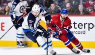 Jacob Trouba #8 of the Winnipeg Jets skates the puck against Alexander Radulov #47 of the Montreal Canadiens during the NHL game at the Bell Centre on February 18, 2017 in Montreal, Quebec, Canada. Minas Panagiotakis/AFP
