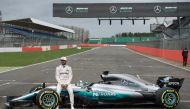 Mercedes AMG Petronas Formula One driver Britain's Lewis Hamilton poses by the new 2017 season Mercedes W08 EQ Power+ Formula One car at its launch event at Silverstone motor racing circuit near Towcester, central England on February 23, 2017. / AFP / OLI