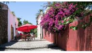 A shady umbrella on a sunny alleyway in Colonia, Uruguay, a UNESCO World Heritage site across the River Platte from Buenos Aires. Photo by Dina Mishev for The Washington Post.
