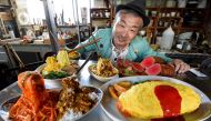 This picture taken on January 18, 2017 shows Norihito Hatanaka, president of Fake Food Hatanaka, introducing plastic food dishes at his company's studio in Tokorozawa, a suburb of Tokyo. They may look good enough to eat, but Japan's mouthwatering food rep