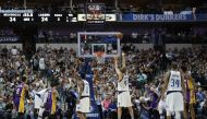 Dirk Nowitzki #41 of the Dallas Mavericks makes a free throw shot against the Los Angeles Lakers at American Airlines Center on March 7, 2017 in Dallas, Texas. Ronald Martinez/AFP
