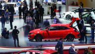 People check cars on the second press day of the Geneva International Motor Show, Europe's biggest annual car show, in Geneva, yesterday.  