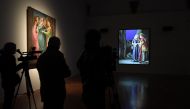 A journalist watches a video by US artist Bill Viola during a press preview of the exhibition 