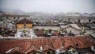 (FILES) This file photo taken on March 1, 2017 shows workers pushing wheelbarrows on the top of Istanbul's iconic marketplace, the Grand Bazaar, during its renovation in Istanbul. AFP / OZAN KOSE
