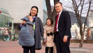 Robert Kelly (R), an expert on East Asian affairs and a professor at South Korea's Pusan National University, his wife Kim Jung-A (L), daughter Marion (2nd R) and toddler son James pose during an interview with AFP at the university in Busan on March 15, 