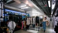 In this picture taken on March 17, 2017, a customer browses clothes in an independant fashion shop in Hong Kong. AFP / Anthony WALLACE 