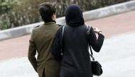 An Iranian couple walk in a park in the capital Tehran on March 14, 2017.  AFP / Atta Kenare