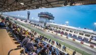 Spectators eagerly wait for till the start of MotoGP Qualifying rounds at the Losail International Circuit yesterday. Torrential rain yesterday afternoon wreaked havoc at the Grand Prix of Qatar, forcing the day's proceedings to be called off.