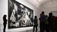 Visitors look at Spanish artist Pablo Picasso's painting, 