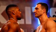 British boxer Anthony Joshua (L) and Ukrainian boxer Wladimir Klitschko (R) face each other during the weigh-in ahead of their world heavyweight title unification bout at Wembley in London on April 28, 2017.  / AFP / Adrian DENNIS
