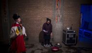 This picture taken on March 30, 2017 shows a Jin opera performer (C) having a footbath backstage after a show at an outdoor theatre in a village in Yuxian, China's Hebei province. AFP / Wang Zhao