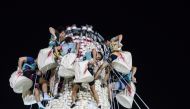 Competitors take part in a scramble up an 18-metre tower made from imitation buns during the annual Cheung Chau bun festival in Hong Kong, shortly after midnight on May 4, 2017. AFP / Anthony Wallace