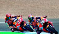 Repsol Honda Team's Spanish rider Dani Pedrosa (right) and his team-mate Marc Marquez of Spain take a curve at Jerez de la Frontera race track during the MotoGP fourth free practice session of the Spanish Red Bull Grand Prix.