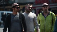 Patients walk on Taksim square after an hair transplant surgery on May 2, 2017 in Istanbul. AFP / OZAN KOSE
