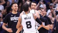 Danny Green #14 hugs Manu Ginobili #20 and Patty Mills #8 of the San Antonio Spurs after an overtime win against the Houston Rockets during Game Five of the Western Conference Semi-Finals at AT&T Center on May 9, 2017 in San Antonio, Texas.  Ronald Martin