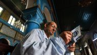 Tunisian Rabbi Daoud reads the torah at the Ghriba Synagogue on the Tunisian resort island of Djerba on May 14, 2017 during the second day of the annual Jewish pilgrimage to the synagogue thought to be Africa's oldest. AFP / Fethi Belaid