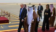 US President Donald Trump (C-L) is welcomed by Saudi King Salman bin Abdulaziz al-Saud (C) upon arrival at King Khalid International Airport in Riyadh on May 20, 2017. AFP / MANDEL NGAN
