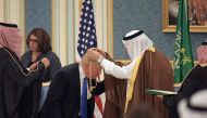 US President Donald Trump (C) receives the Order of Abdulaziz al-Saud medal from Saudi Arabia's King Salman bin Abdulaziz al-Saud (R) at the Saudi Royal Court in Riyadh on May 20, 2017.  AFP / MANDEL NGAN
