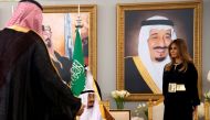 U.S. first lady Melania Trump (R) takes her seat next to The Custodian of the Two Holy Mosques King Salman bin Abdulaziz Al Saud of Saudi Arabia (seated-L) as he welcomes her and U.S. President Donald Trump (not pictured) with a coffee ceremony in the Roy