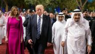 A handout picture provided by the Saudi Royal Palace on May 20, 2017, shows US President Donald Trump (C), accompanied by First Lady Melania Trump (L), and Saudi King arriving for a reception ahead of a banquet at Murabba Palace in Riyadh. AFP PHOTO / SAU