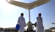 Visitors walk past aircraft on display during the Middle East Business Aviation show at Al Maktoum International Airport in Dubai World Central, December 11, 2012. REUTERS/Jumana El Heloueh