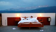 Raphael and Mirjam (R) pose as first guests in the bedroom of the Null-Stern-Hotel (Zero-star-hotel) land art installation by Swiss artists Frank and Patrik Riklin on an alp near Gonten, Switzerland June 1, 2017. REUTERS/Arnd Wiegmann 