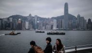 (FILES) This file picture taken on December 17, 2016 shows mainland Chinese tourists visiting a viewing deck overlooking Victoria Harbour in Hong Kong. AFP / Dale DE LA REY