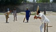 In this photograph taken on July 6, 2017, Afghan refugees play a cricket match at the Khurasan refugee camp in the suburbs of Peshawar. 