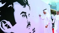 Sheikh Khalid bin Mohammed bin Ali Al Thani, Chairman of the Board of Directors of QIC, signing the mural in the presence of Khalifa Abdullah Turki Al Subaey, Group President & CEO of QIC Group. 