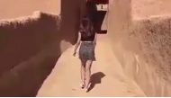 The Saudi woman, identified as Model Khulood, appeared on a Snapchat clip strolling through an empty mudbrick village alleyway, wearing a short skirt and a top that exposed her midriff.