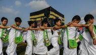 Ihram-clad Malaysian Muslim boys from the Little Caliphs kindergarten circumambulate a mockup of the Kaaba, Islam's most sacred structure located in the holy city of Makkah, during an educational simulation of the Haj pilgrimage in Shah Alam, outside Kual