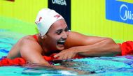 Kylie Masse of Canada reacts after winning the race and breaking a world record.