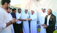 Qatari artist Ahmed Al Maadheed of the Tamim Al Majd unity icon along with other officials at the launch of the magazine.