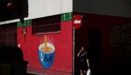 A woman walks past a Chinese food store at Usera district in Madrid, Spain, July 24, 2017. Reuters /Susana Vera