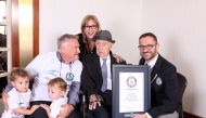 Marco Frigatti (R), Head of Records for Guinness World Records, presenting Israel Kristal (2nd-R) with his certificate of achievement for Oldest Living man, in the presence of the Kristal's daughter (top, son (L) and grandchildren In this picture released