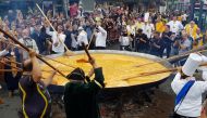 Members of the worldwide fraternity of the omelette prepare a traditional giant omelette made with 10,000 eggs in Malmedy, Belgium August 15, 2017. Reuters/Christopher Stern