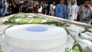 Visitors watch a scale model of Al Thumama Stadium which was unveiled at Hamad International Airport in Doha yesterday. Picture by: Salim Matramkot/The Peninsula.