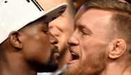 Boxer Floyd Mayweather Jr. (L) and UFC lightweight champion Conor McGregor face off during their official weigh-in at T-Mobile Arena on August 25, 2017 in Las Vegas, Nevada. (Ethan Miller/Getty Images/AFP)