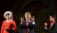 In this picture taken on August 11, 2017, Nepali comedian Manoj Gajurel (C) performs in a show impersonating US President Donald Trump in Kathmandu.  AFP / PRAKASH MATHEMA
