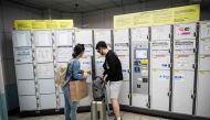 In this picture taken on September 4, 2017, a couple use a coin locker in Roppongi subway station in Tokyo.  AFP / Behrouz MEHRI
