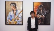 Rolling Stones guitarist Ronnie Wood discusses his art during a news conference at his 