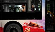 Passengers are seen on a bus, promoting the 19th National Congress of the Communist Party of China (CPC) in Shanghai, China September 26, 2017. Reuters/Aly Song