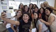 In this picture taken on September 3, 2017, Joy Carbonell takes a selfie with fellow members of the 