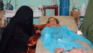 A woman sits next to her daughter who was injured in a Saudi-led air strike, at the hospital in the northwestern city of Saada, Yemen, yesterday.